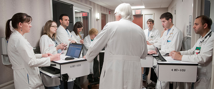 ICU pharmacist Cathy Pierce with Resident, Elizabeth Connolly while on rounds with Dr. Edward Haponik, 4 Reynolds Tower.